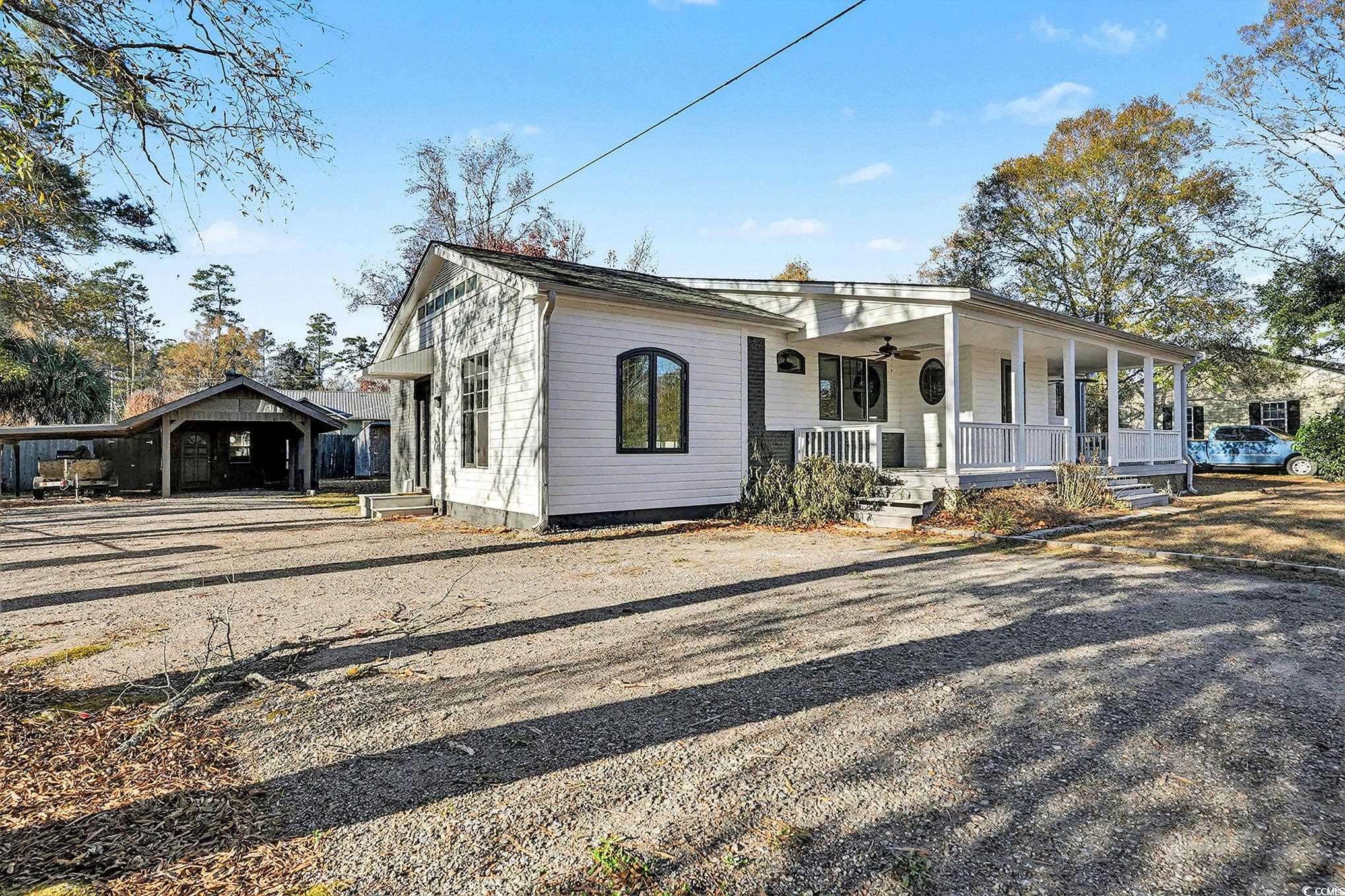 218 Busbee Street Conway, SC 29526 - Photo 29 of 30 View of front facade featuring covered porch, a carport, and driveway