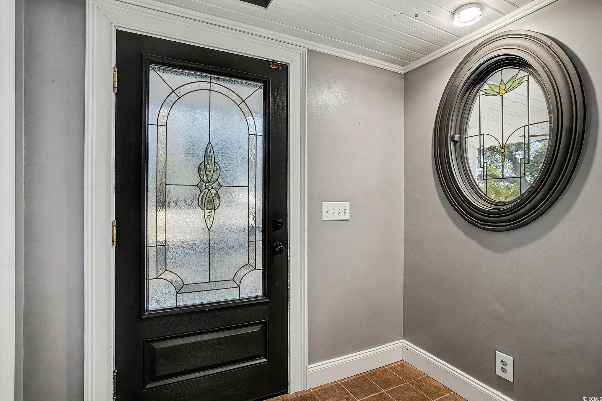218 Busbee Street Conway, SC 29526 - Photo 4 of 30 Foyer entrance with crown molding and dark tile patterned floors