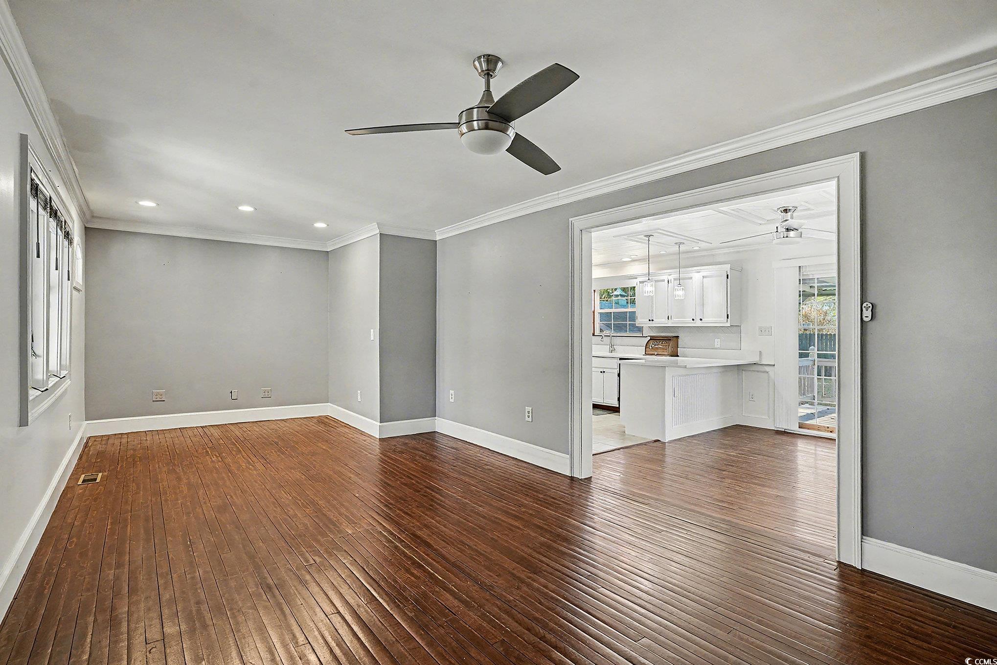 218 Busbee Street Conway, SC 29526 - Photo 5 of 30 Unfurnished living room with ceiling fan, crown molding, dark wood-type flooring, and recessed lighting