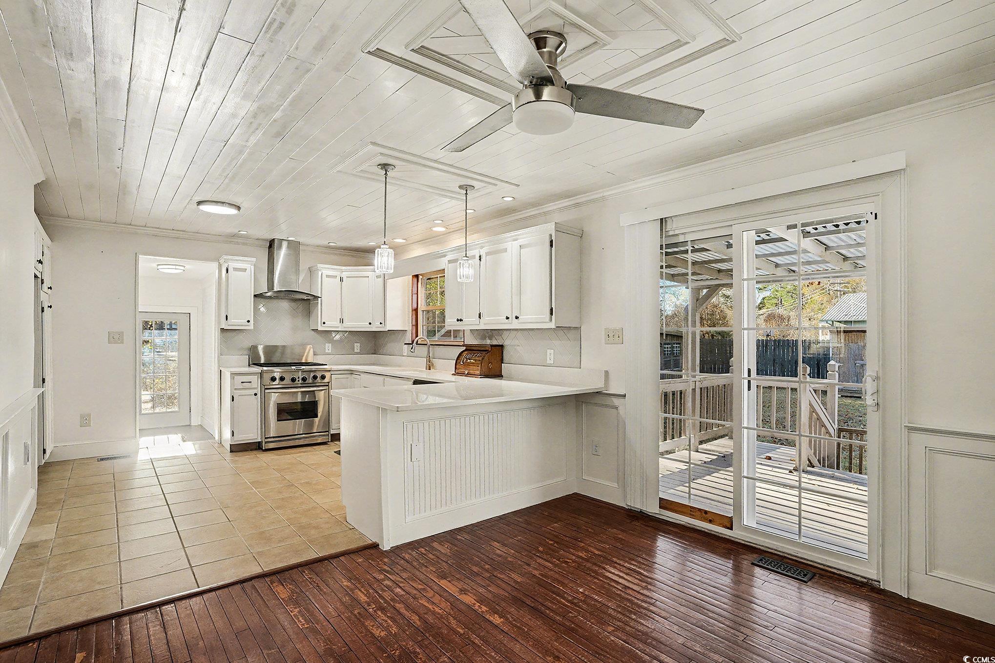 218 Busbee Street Conway, SC 29526 - Photo 8 of 30 Kitchen featuring wooden ceiling, light countertops, white cabinets, stainless steel range, and hanging light fixtures