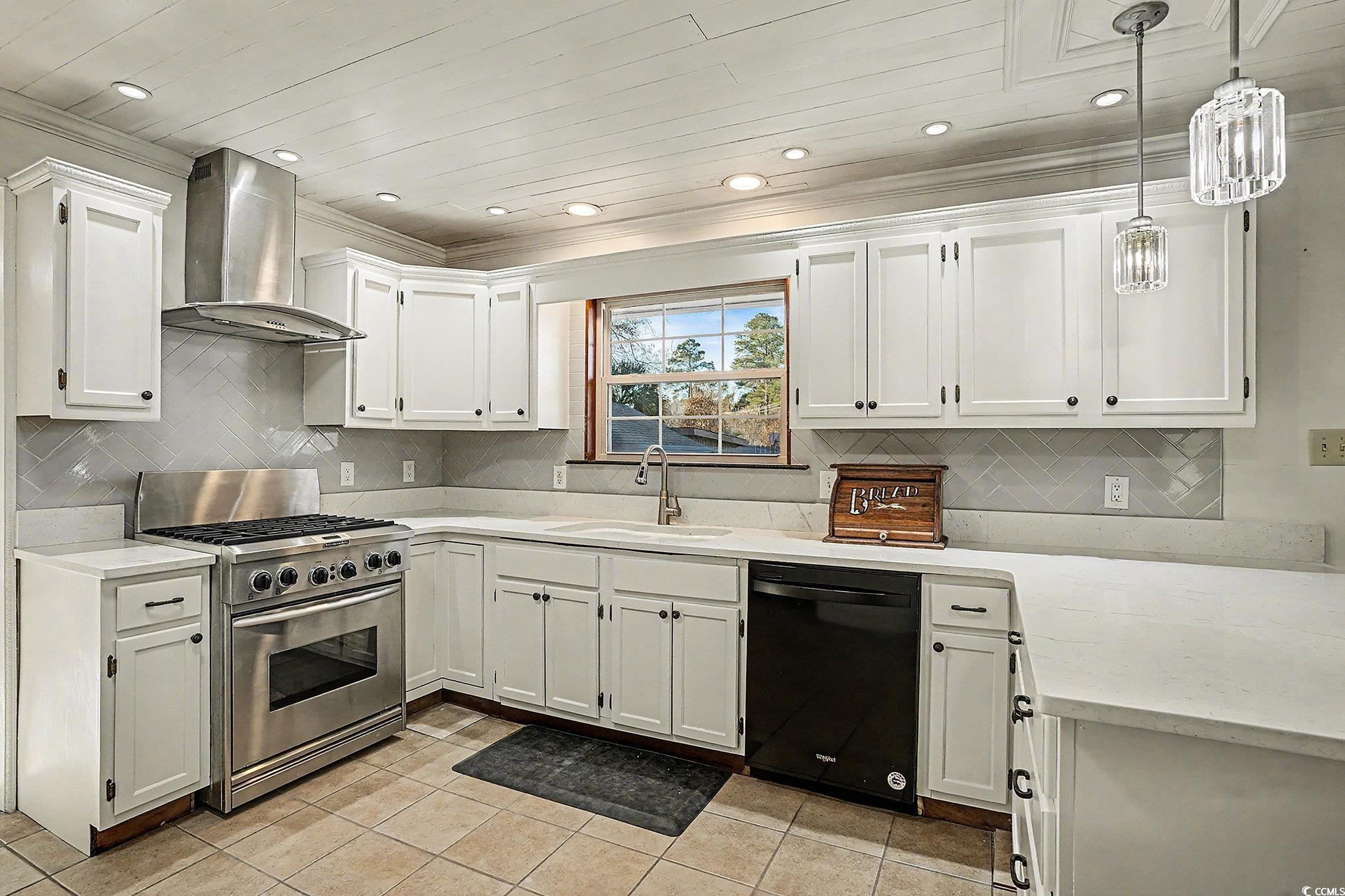 218 Busbee Street Conway, SC 29526 - Photo 10 of 30 Kitchen with dishwasher, stainless steel stove, wall chimney range hood, light stone countertops, and white cabinetry