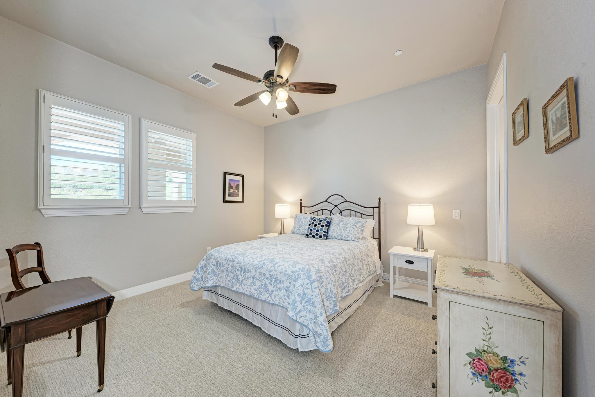 2601 North Quinlan Park Road, Unit 506 Austin, TX 78732 - Photo 27 of 39 Well-lit sleeping quarters feature plantation-style window treatments and soft carpeting underfoot.