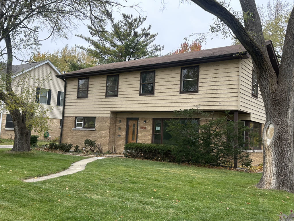 2272 Asbury Road Northbrook, IL 60062 - Photo 1 of 22 a front view of a house with a garden