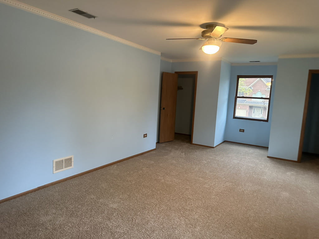 2272 Asbury Road Northbrook, IL 60062 - Photo 15 of 22 an empty room with windows and fan