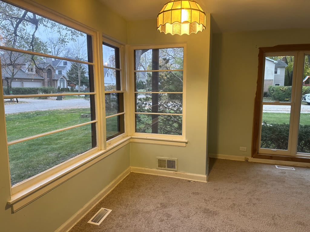2272 Asbury Road Northbrook, IL 60062 - Photo 4 of 22 a view of an empty room with a window and a kitchen view