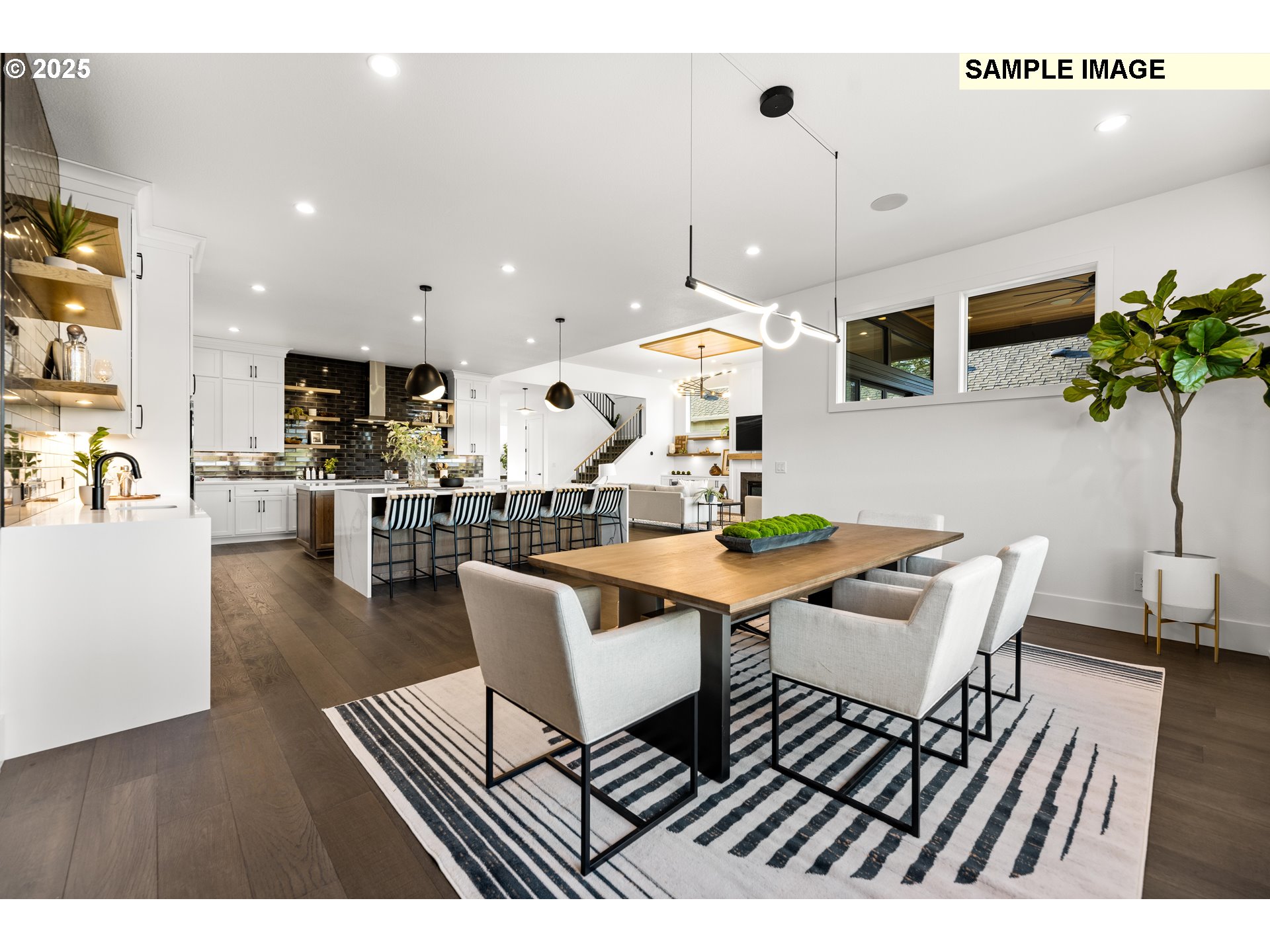 2003 Northwest 121st Street Vancouver, WA 98685 - Photo 19 of 48 a living room with couches a dining table and kitchen view with wooden floor