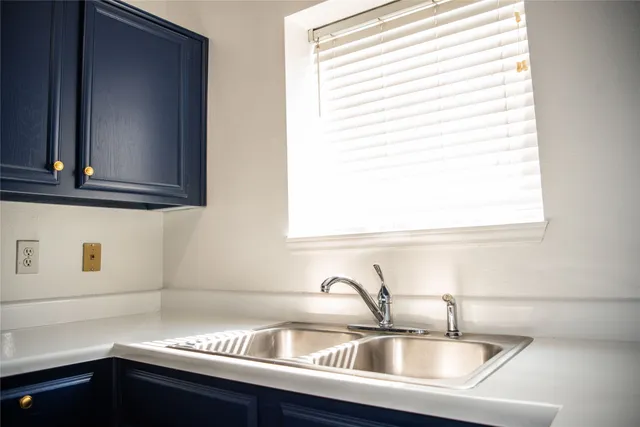 a kitchen with a sink and a window