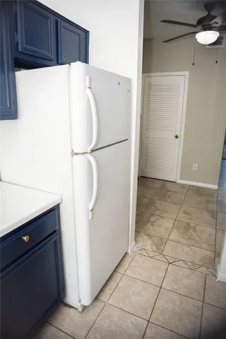 a white refrigerator freezer sitting in a kitchen