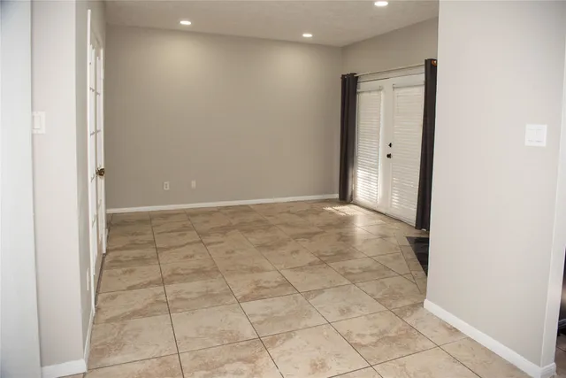 an empty room with white walls and tiles
