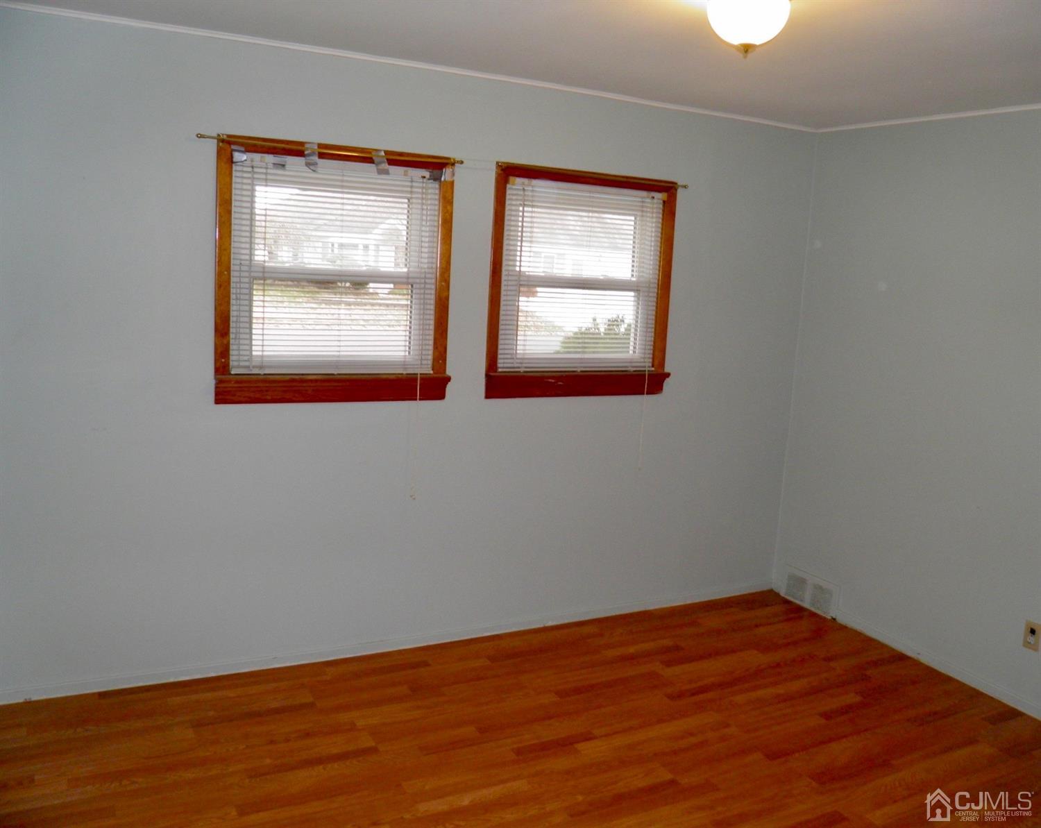 5 Idlewild Road Edison, NJ 08817 - Photo 12 of 13 an empty room with wooden floor and windows