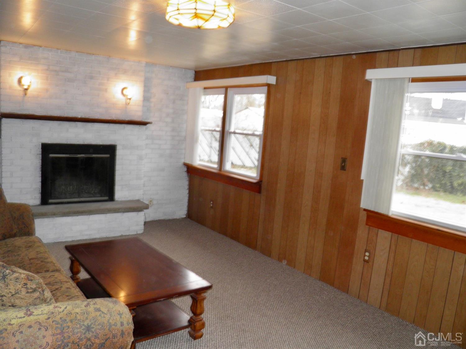5 Idlewild Road Edison, NJ 08817 - Photo 8 of 13 a living room with furniture a fireplace and a window