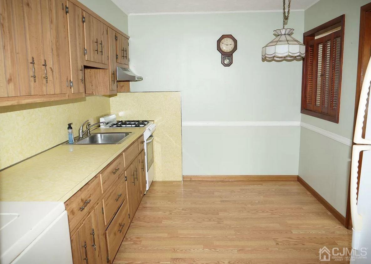 5 Idlewild Road Edison, NJ 08817 - Photo 9 of 13 a kitchen with stainless steel appliances granite countertop a refrigerator a sink dishwasher and wooden cabinets