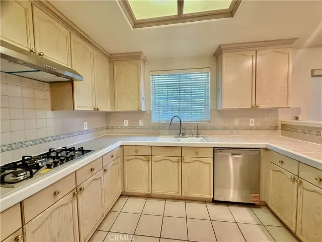 a white kitchen with a sink and cabinets