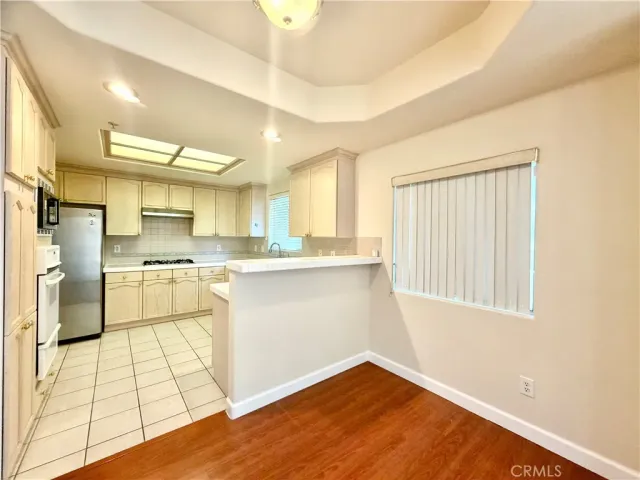 a kitchen with granite countertop a sink cabinets and stainless steel appliances