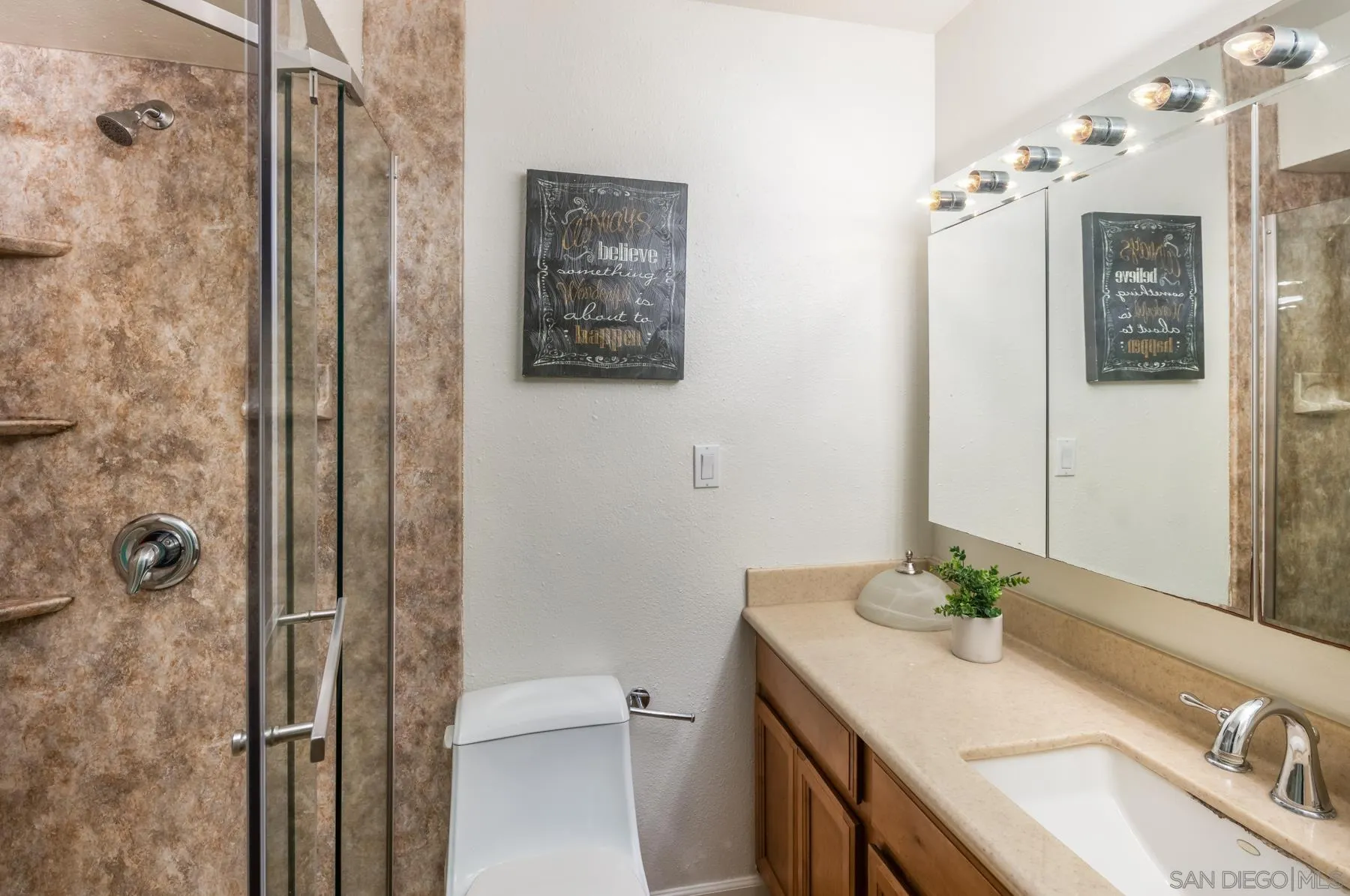 6455 La Jolla Boulevard, Unit 203 La Jolla, CA 92037 - Photo 12 of 21 a bathroom with a granite countertop sink a mirror and shower