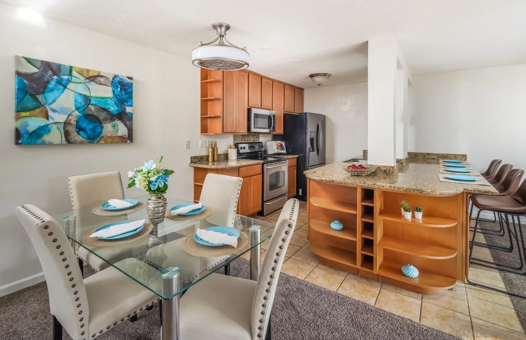 6455 La Jolla Boulevard, Unit 203 La Jolla, CA 92037 - Photo 8 of 21 a view of a dining room with furniture a chandelier and wooden floor