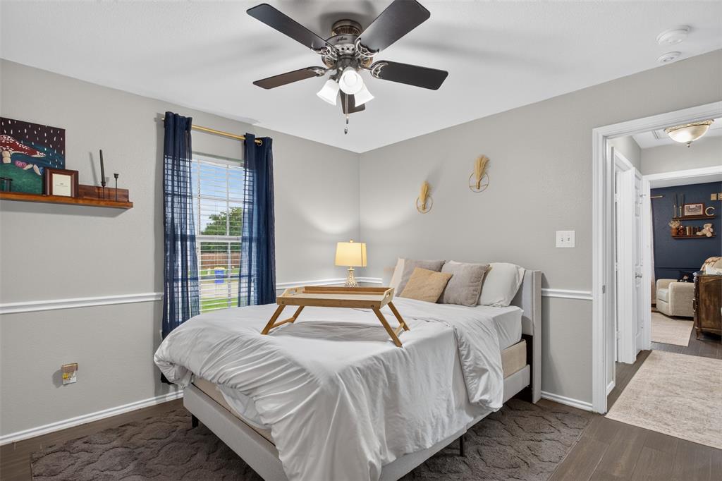 100 Radecke Road Krum, TX 76249 - Photo 19 of 29 Room featuring dark wood-finish flooring, light gray wall paint, and white crown molding