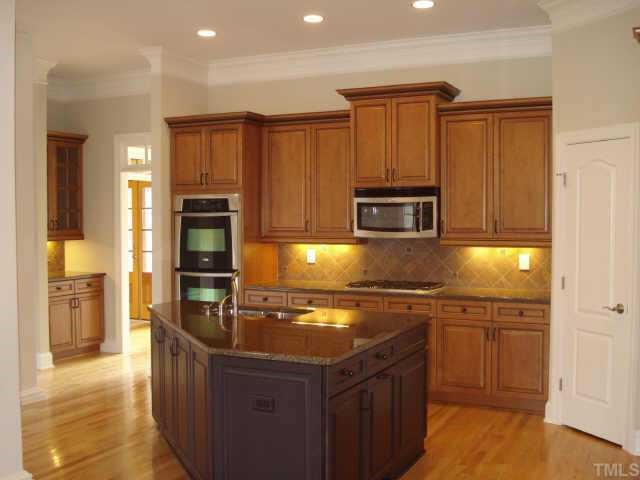 5308 Landguard Drive Raleigh, NC 27613 - Photo 4 of 12 a kitchen with stainless steel appliances granite countertop a stove a sink and a microwave