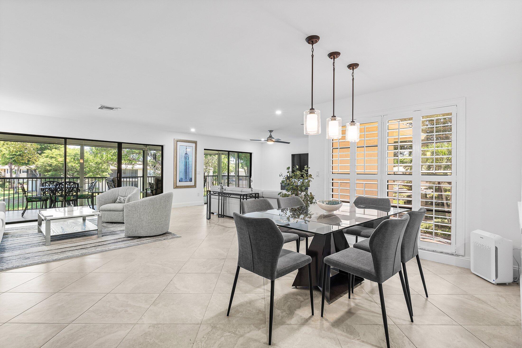 36 Westgate Lane, Unit D Boynton Beach, FL 33436 - Photo 1 of 51 a living room with furniture and a large window