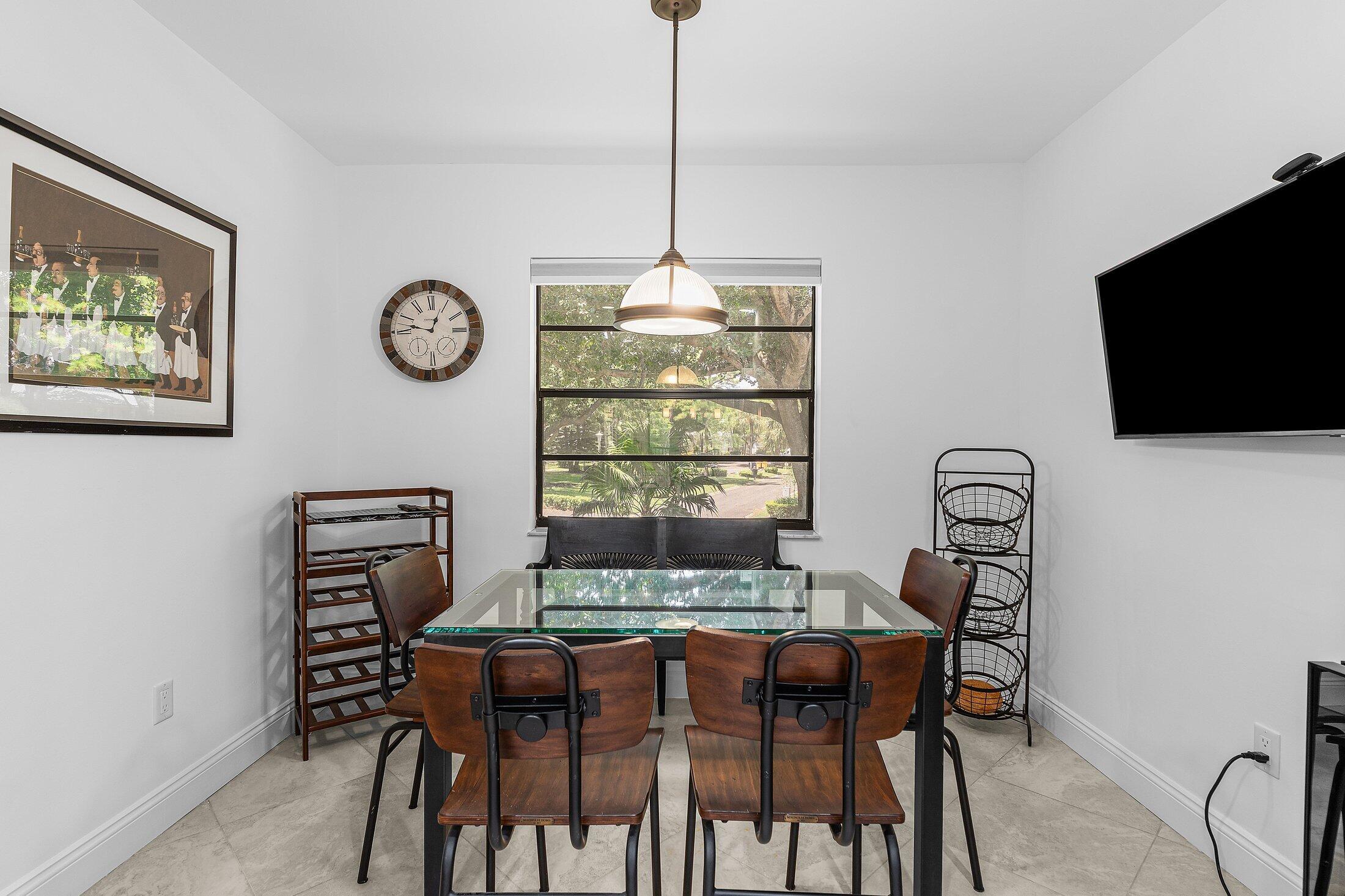 36 Westgate Lane, Unit D Boynton Beach, FL 33436 - Photo 13 of 51 a view of a dining room with furniture window and wooden floor