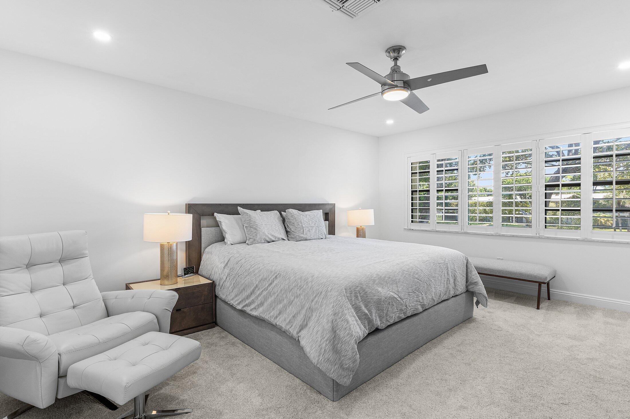 36 Westgate Lane, Unit D Boynton Beach, FL 33436 - Photo 14 of 51 a bedroom with bed and a large window