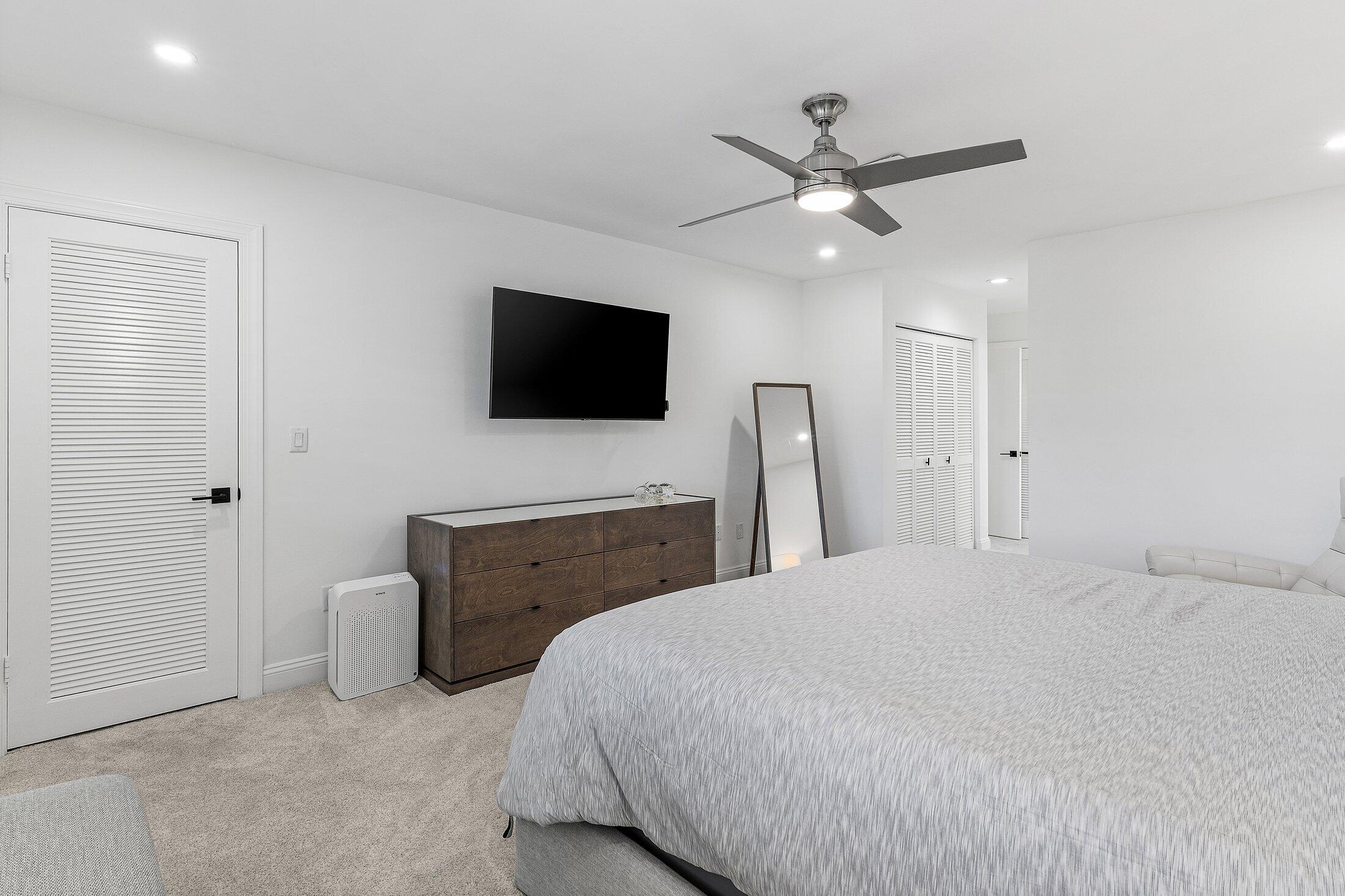 36 Westgate Lane, Unit D Boynton Beach, FL 33436 - Photo 15 of 51 a bedroom with a bed and a flat screen tv