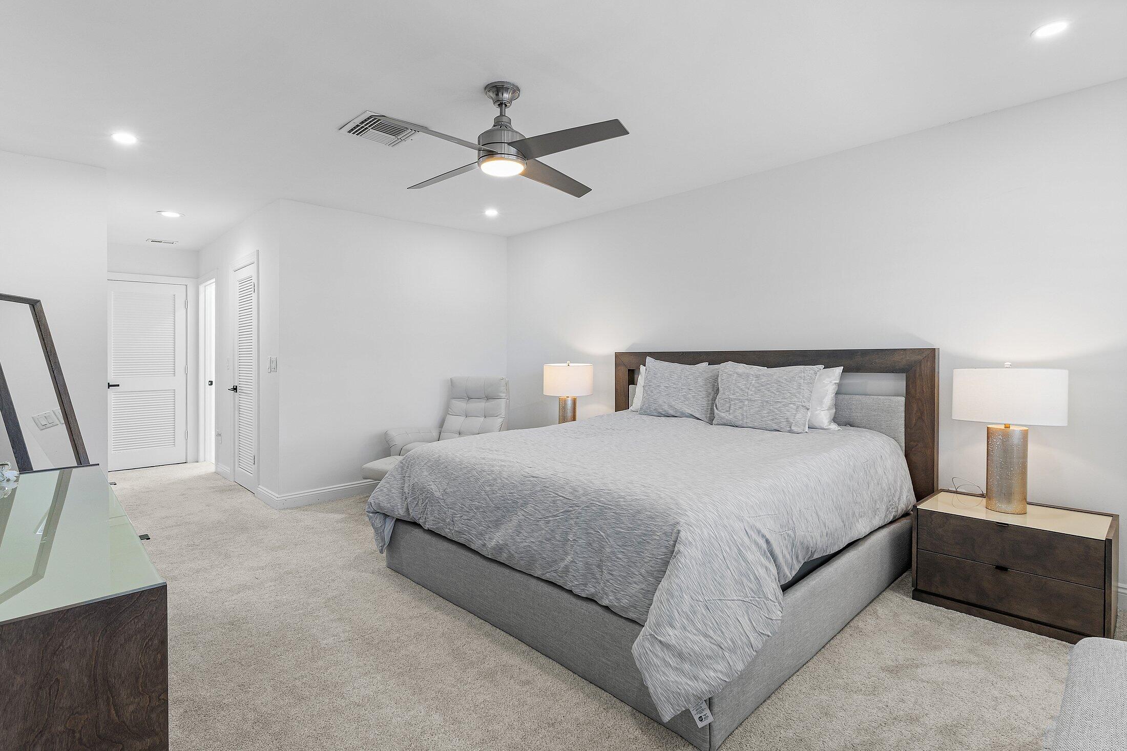 36 Westgate Lane, Unit D Boynton Beach, FL 33436 - Photo 16 of 51 a bedroom with a bed and a chandelier