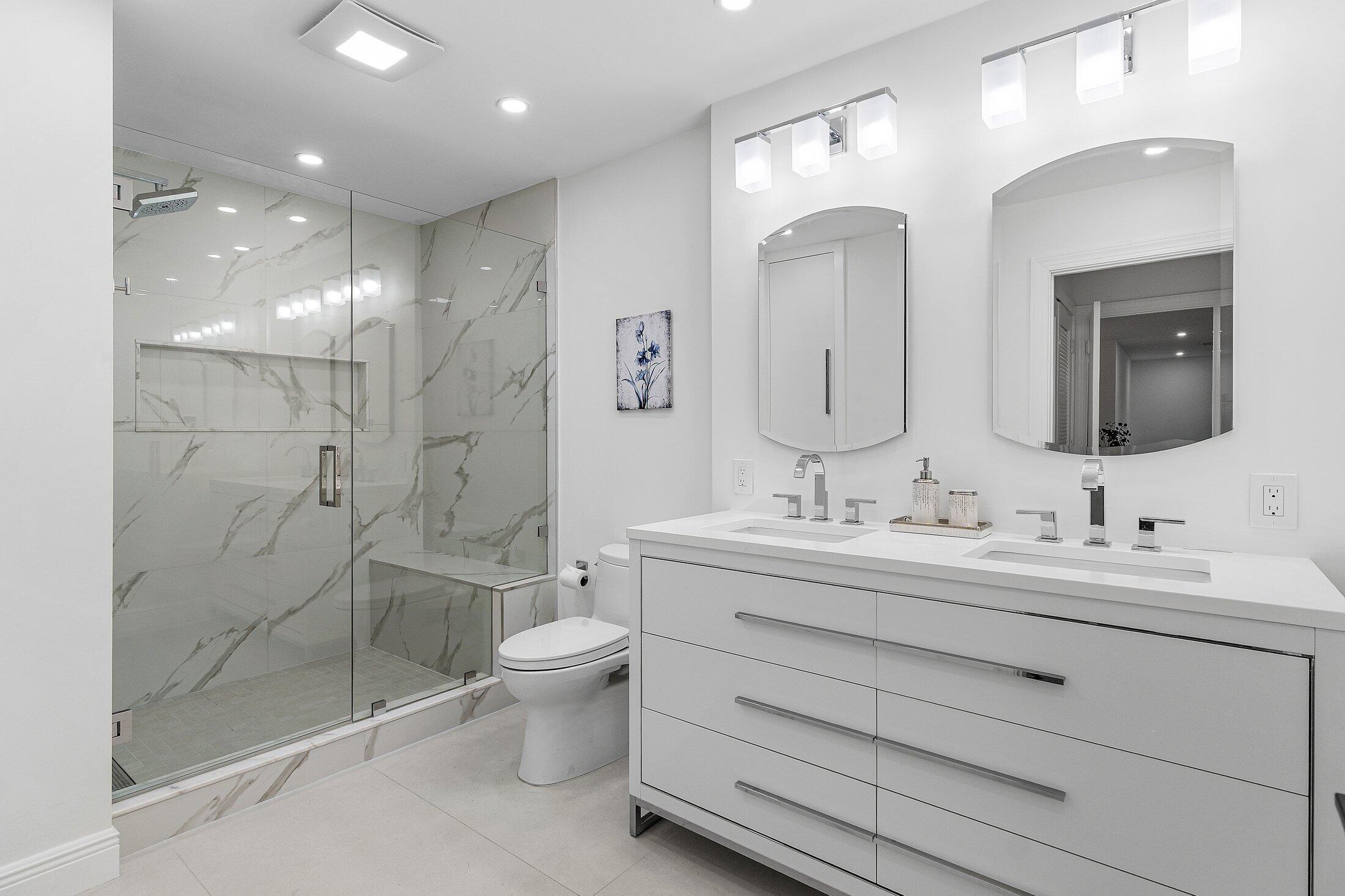 36 Westgate Lane, Unit D Boynton Beach, FL 33436 - Photo 17 of 51 a bathroom with a double vanity sink mirror and toilet