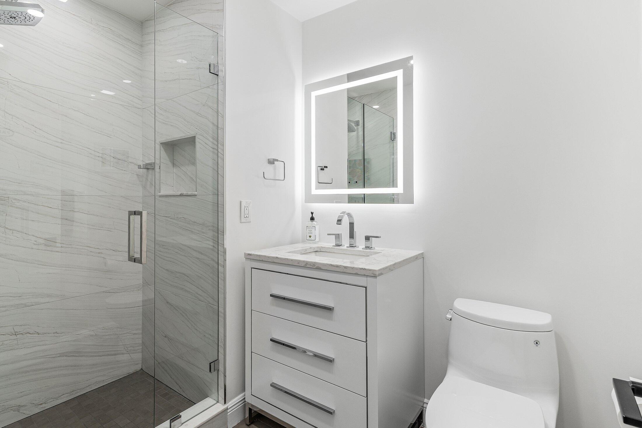 36 Westgate Lane, Unit D Boynton Beach, FL 33436 - Photo 21 of 51 a bathroom with a sink a toilet and shower