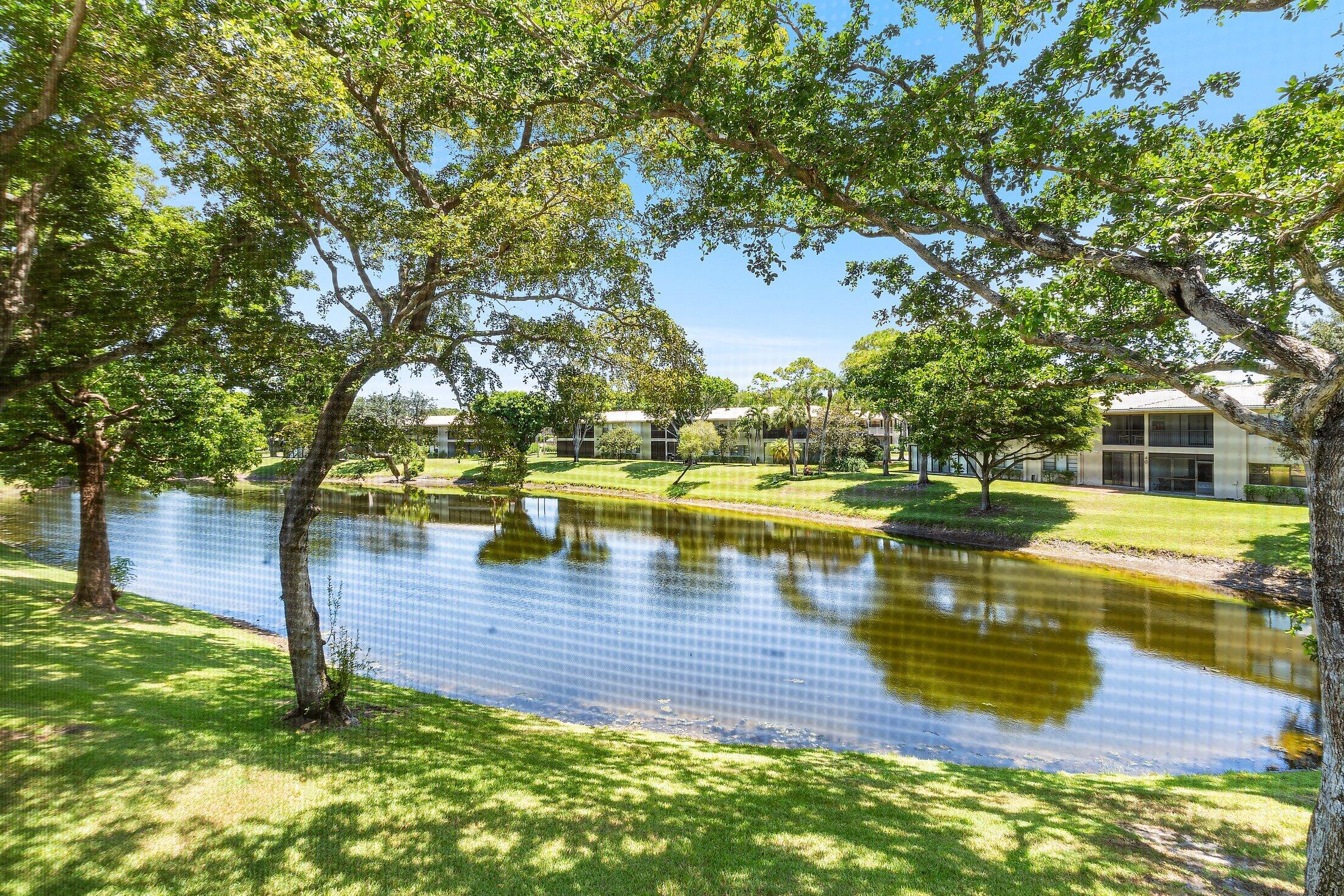 36 Westgate Lane, Unit D Boynton Beach, FL 33436 - Photo 26 of 51 a view of a lake with a yard
