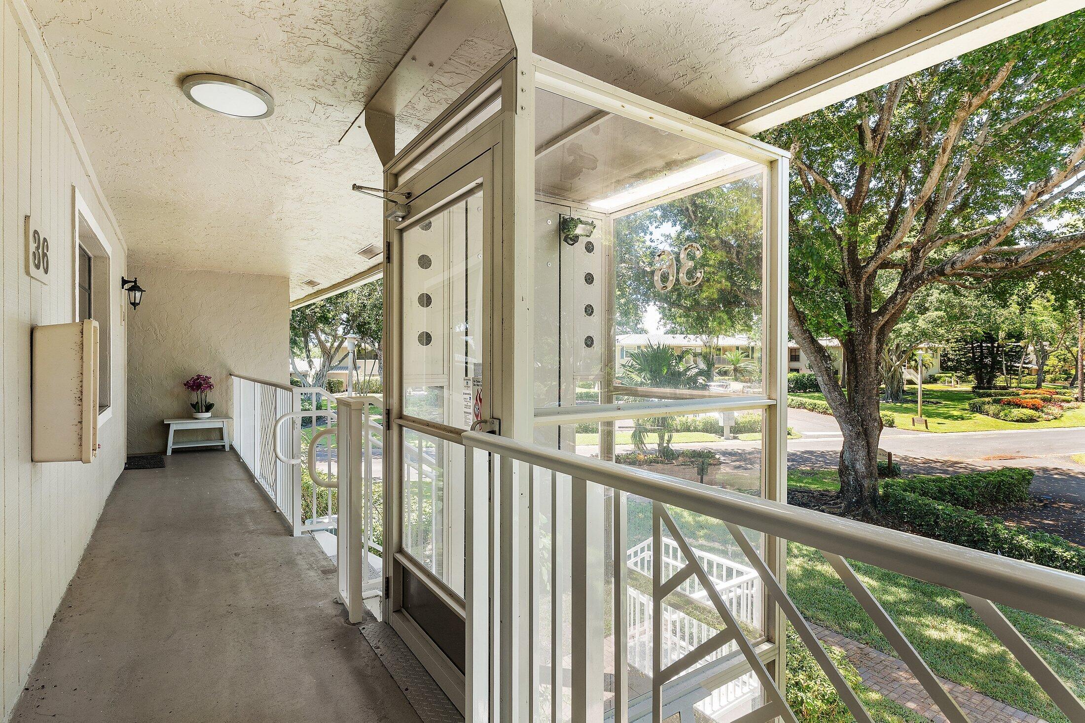36 Westgate Lane, Unit D Boynton Beach, FL 33436 - Photo 28 of 51 a view of a porch with wooden floor and outdoor space