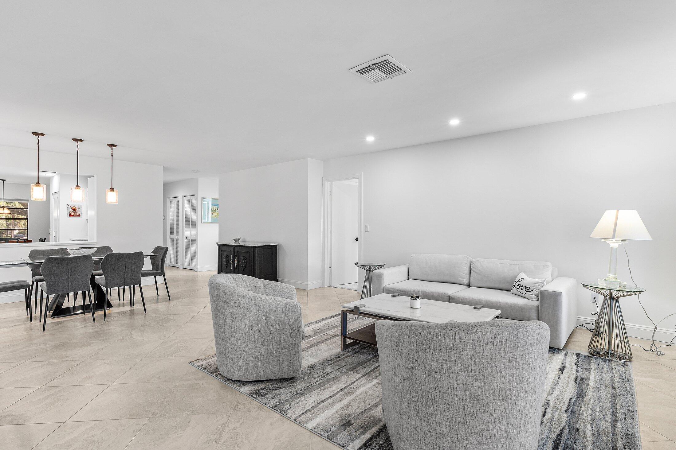36 Westgate Lane, Unit D Boynton Beach, FL 33436 - Photo 5 of 51 a living room with furniture and a flat screen tv