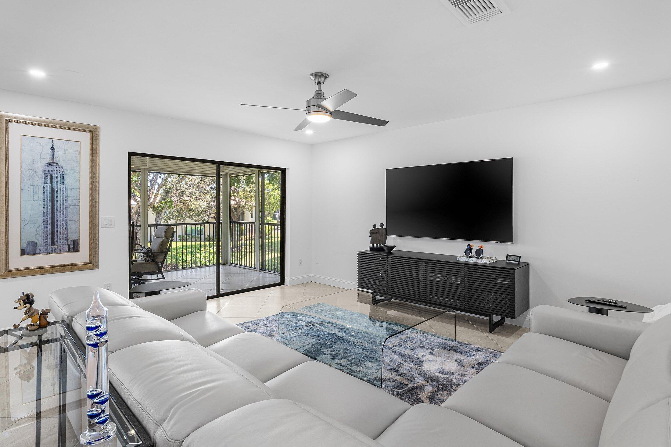 36 Westgate Lane, Unit D Boynton Beach, FL 33436 - Photo 7 of 51 a living room with furniture and a flat screen tv