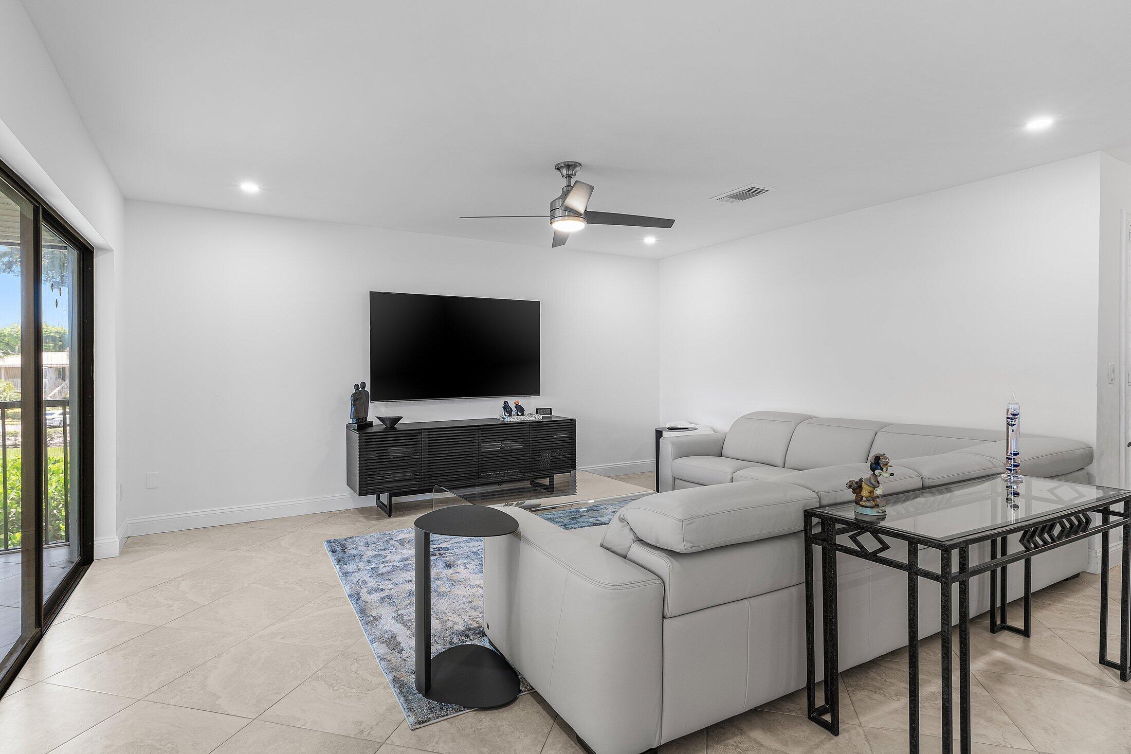 36 Westgate Lane, Unit D Boynton Beach, FL 33436 - Photo 8 of 51 a living room with furniture and a flat screen tv