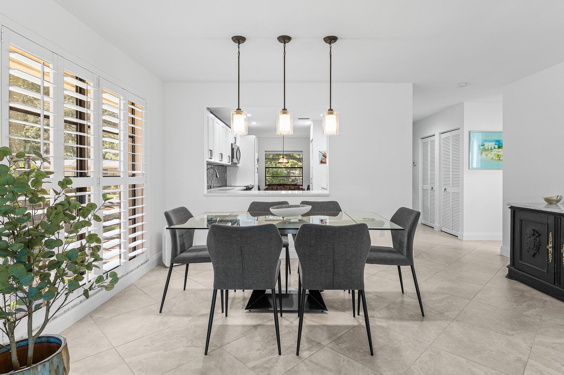 36 Westgate Lane, Unit D Boynton Beach, FL 33436 - Photo 9 of 51 a view of a dining room with furniture window and outside view