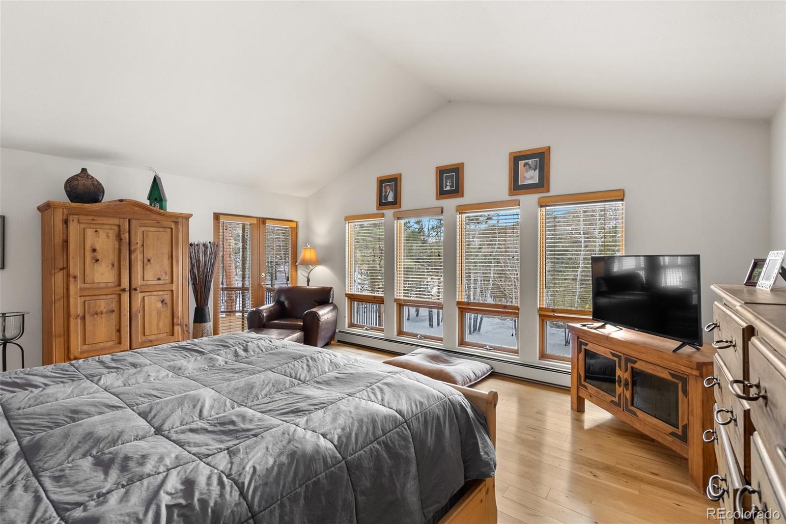 420 Stagecoach Boulevard Evergreen, CO 80439 - Photo 21 of 49 a bedroom with a bed flat screen tv and a large window