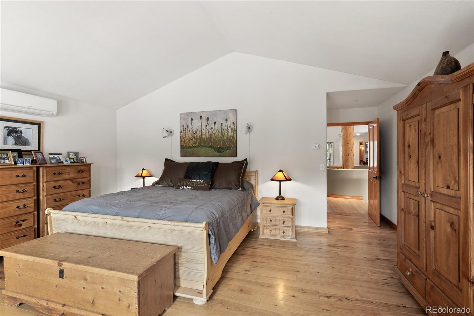 420 Stagecoach Boulevard Evergreen, CO 80439 - Photo 22 of 49 a bedroom with a bed and wooden floor