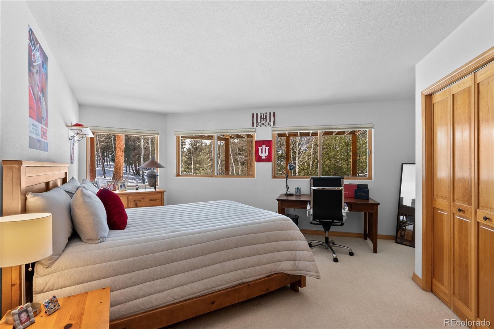 420 Stagecoach Boulevard Evergreen, CO 80439 - Photo 29 of 49 a bedroom with a bed and large window