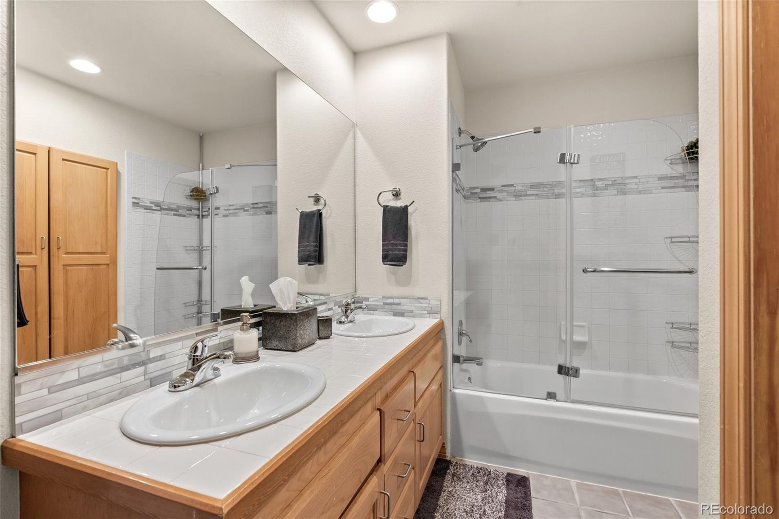 420 Stagecoach Boulevard Evergreen, CO 80439 - Photo 33 of 49 a bathroom with a tub sink double vanity and mirror