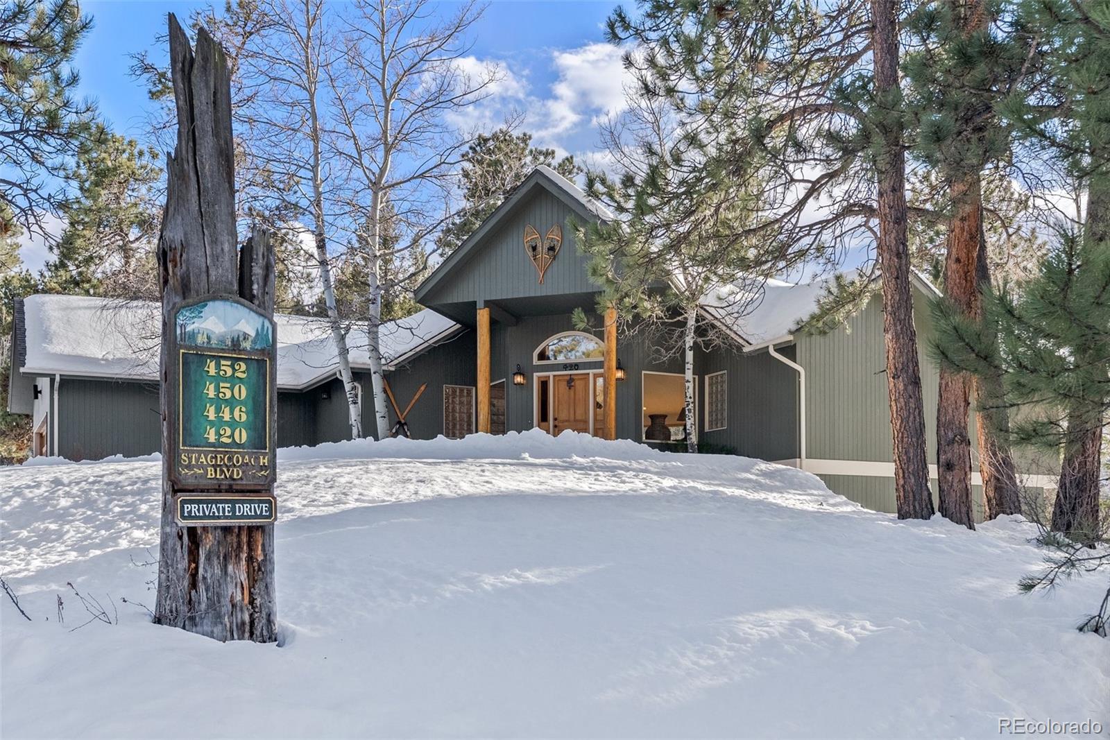 420 Stagecoach Boulevard Evergreen, CO 80439 - Photo 43 of 49 a front view of a house with a yard and garage