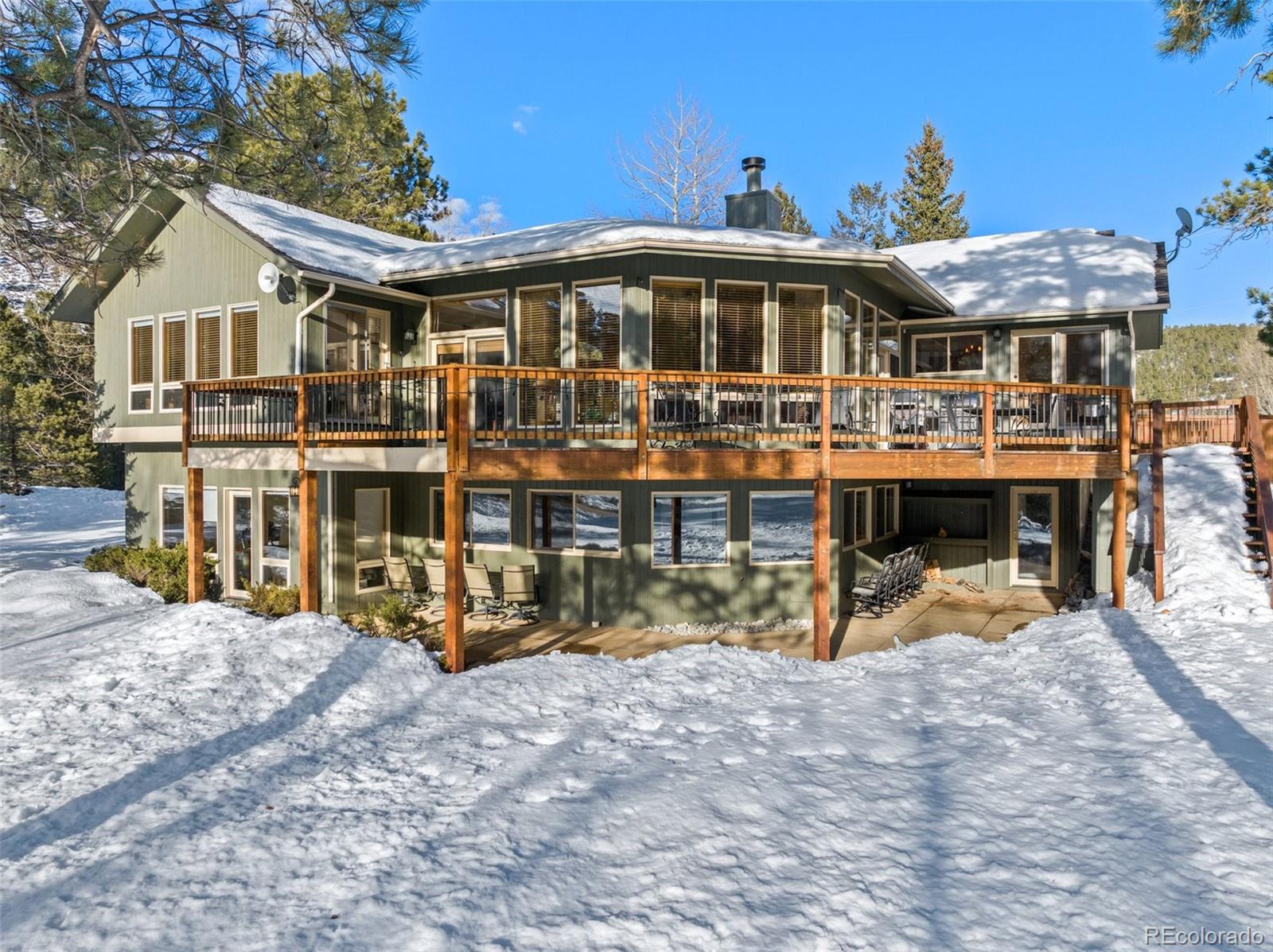 420 Stagecoach Boulevard Evergreen, CO 80439 - Photo 45 of 49 a view of a house with wooden deck and a big yard