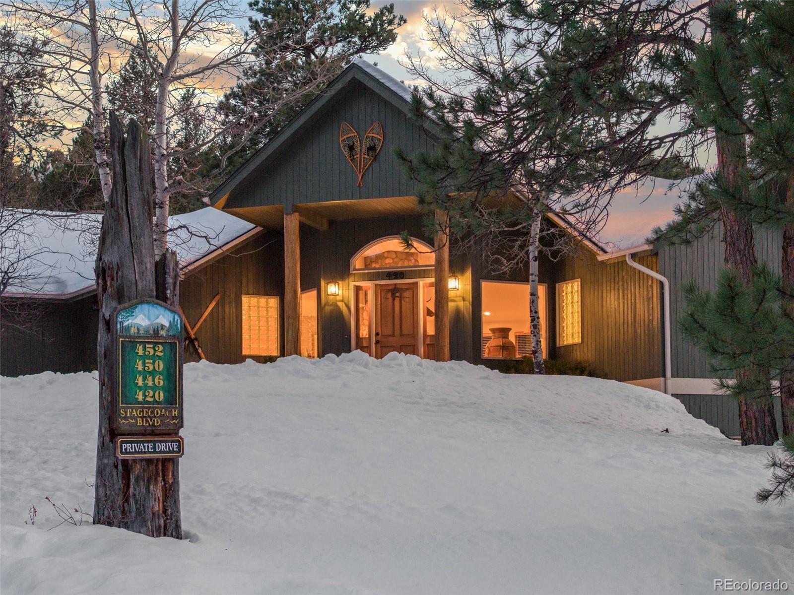 420 Stagecoach Boulevard Evergreen, CO 80439 - Photo 48 of 49 a front view of a house with a yard and garage