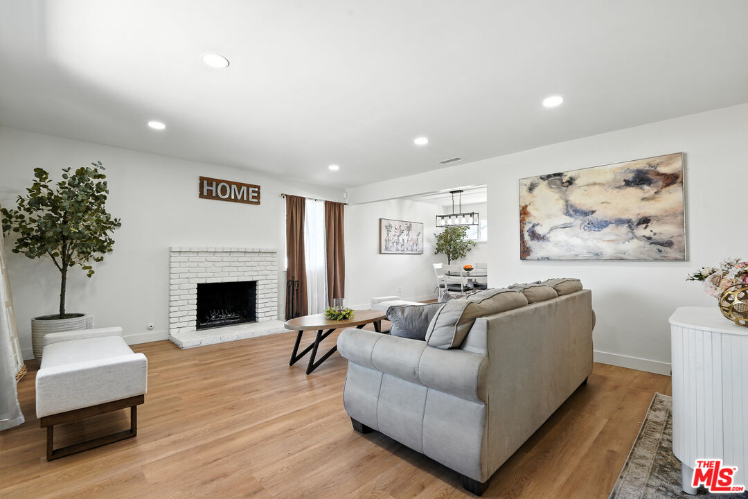 21312 Island Avenue Carson, CA 90745 - Photo 2 of 26 a living room with furniture and a fireplace