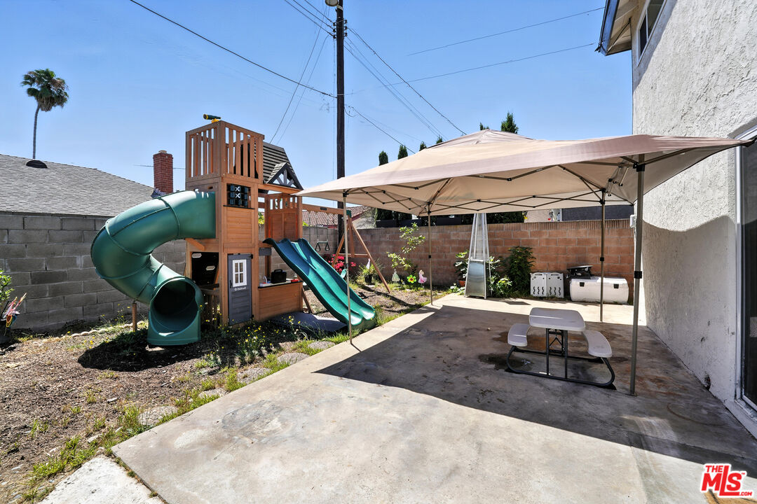 21312 Island Avenue Carson, CA 90745 - Photo 22 of 26 a view of a patio with table and chairs under an umbrella