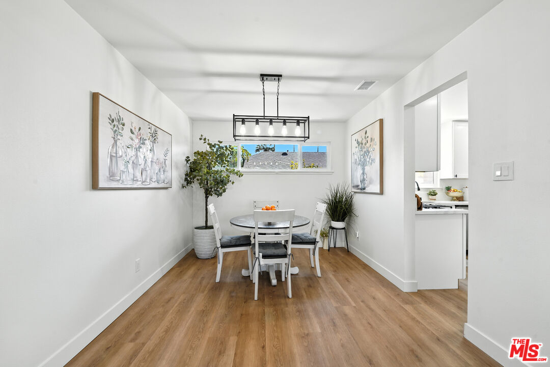21312 Island Avenue Carson, CA 90745 - Photo 5 of 26 a view of a dining room with furniture wooden floor and chandelier