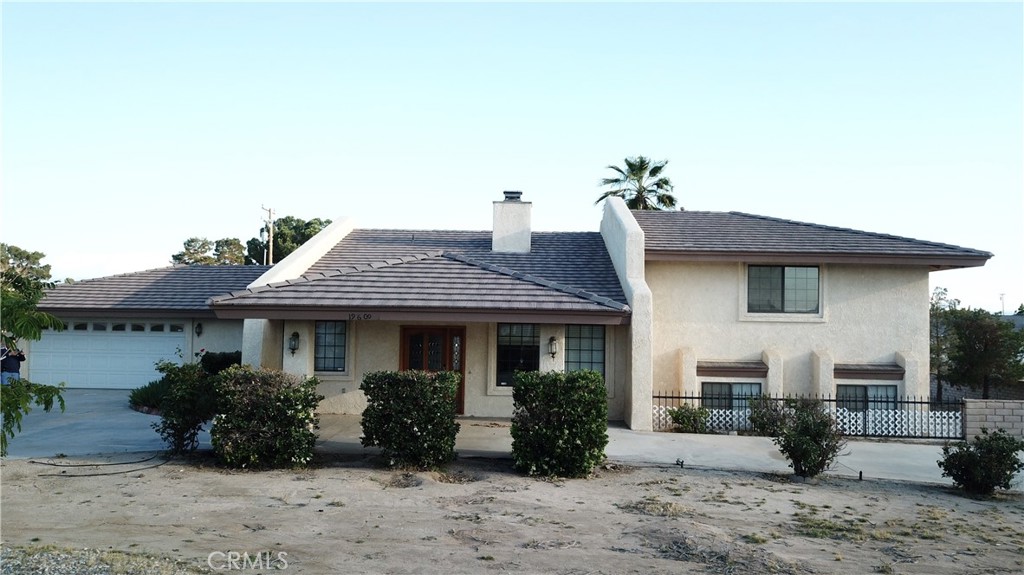 19609 Seneca Road Apple Valley, CA 92307 - Photo 2 of 37 a front view of a house with a yard