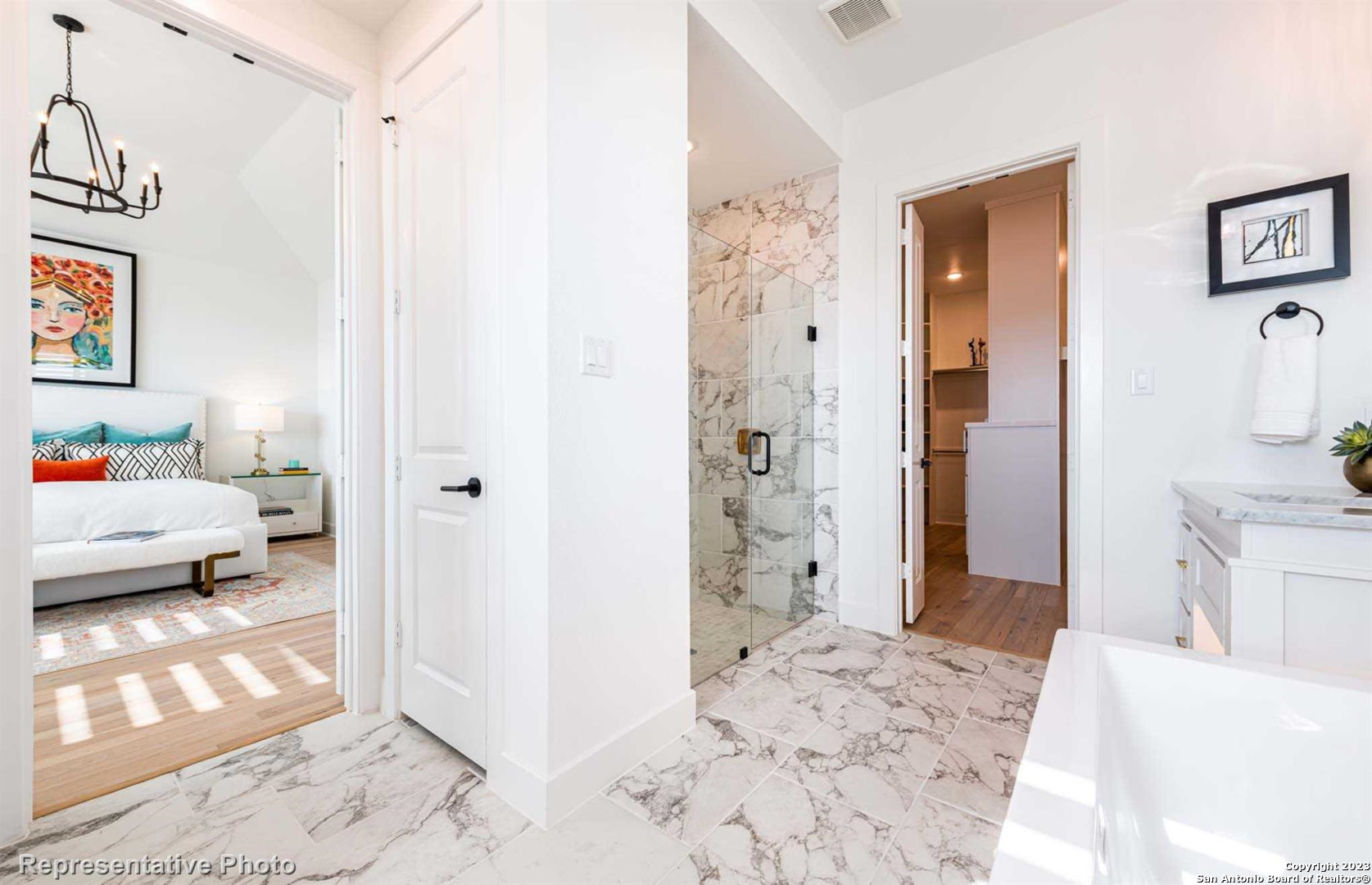 a bedroom with a bed and a view of living room