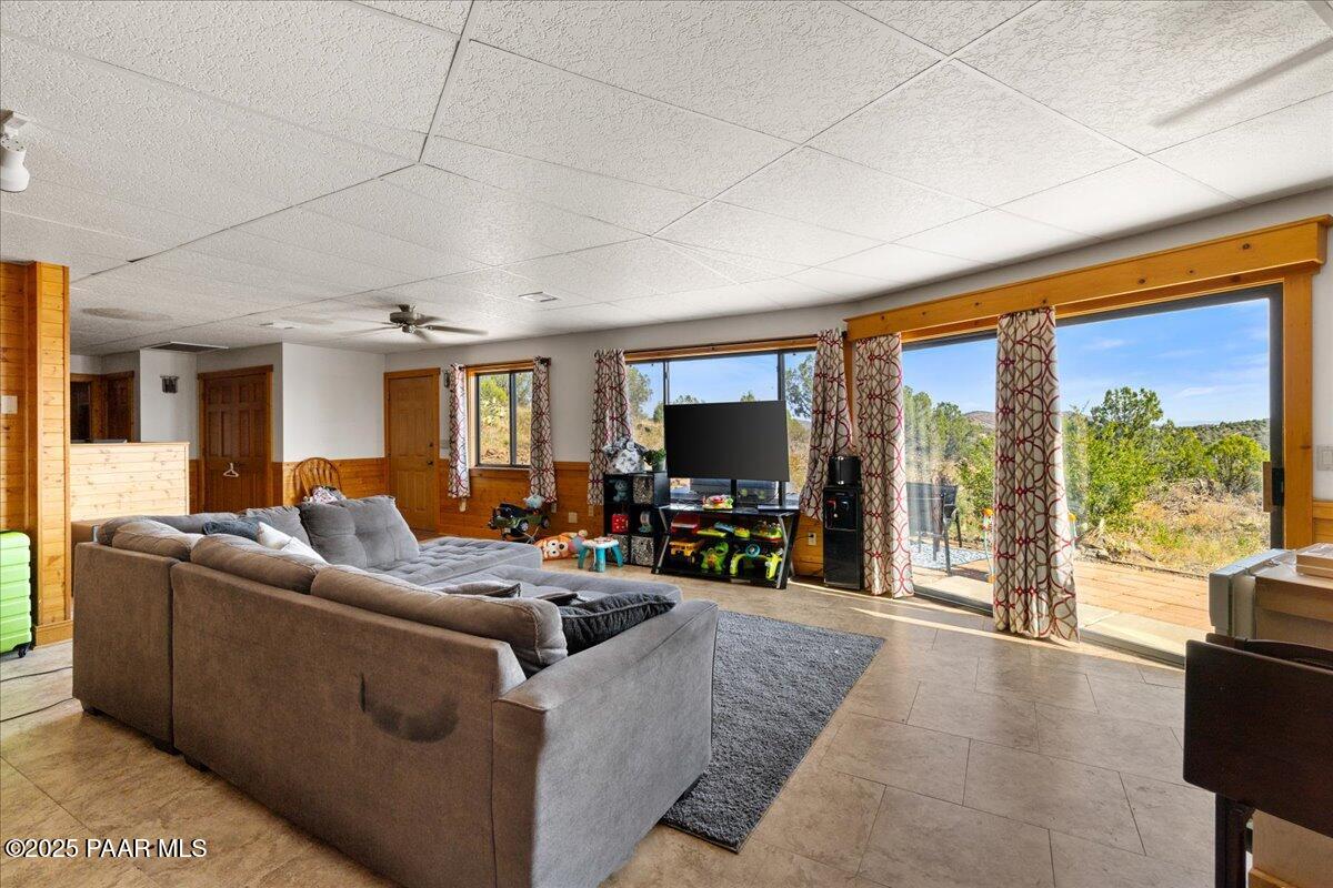 14195 Tapper Trail Prescott, AZ 86305 - Photo 31 of 46 a living room with furniture a floor to ceiling window and a flat screen tv