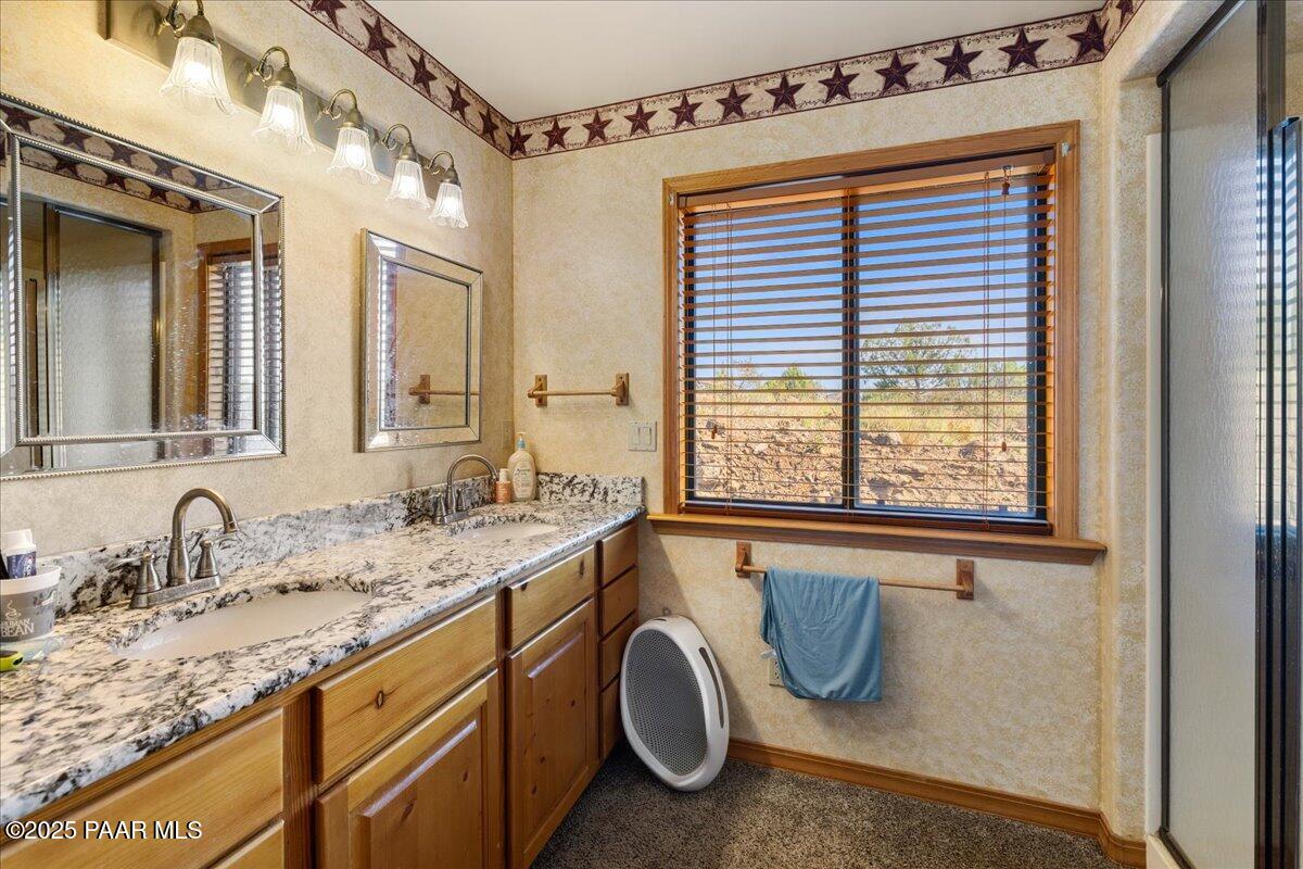 14195 Tapper Trail Prescott, AZ 86305 - Photo 33 of 46 a bathroom with a granite countertop sink and a window