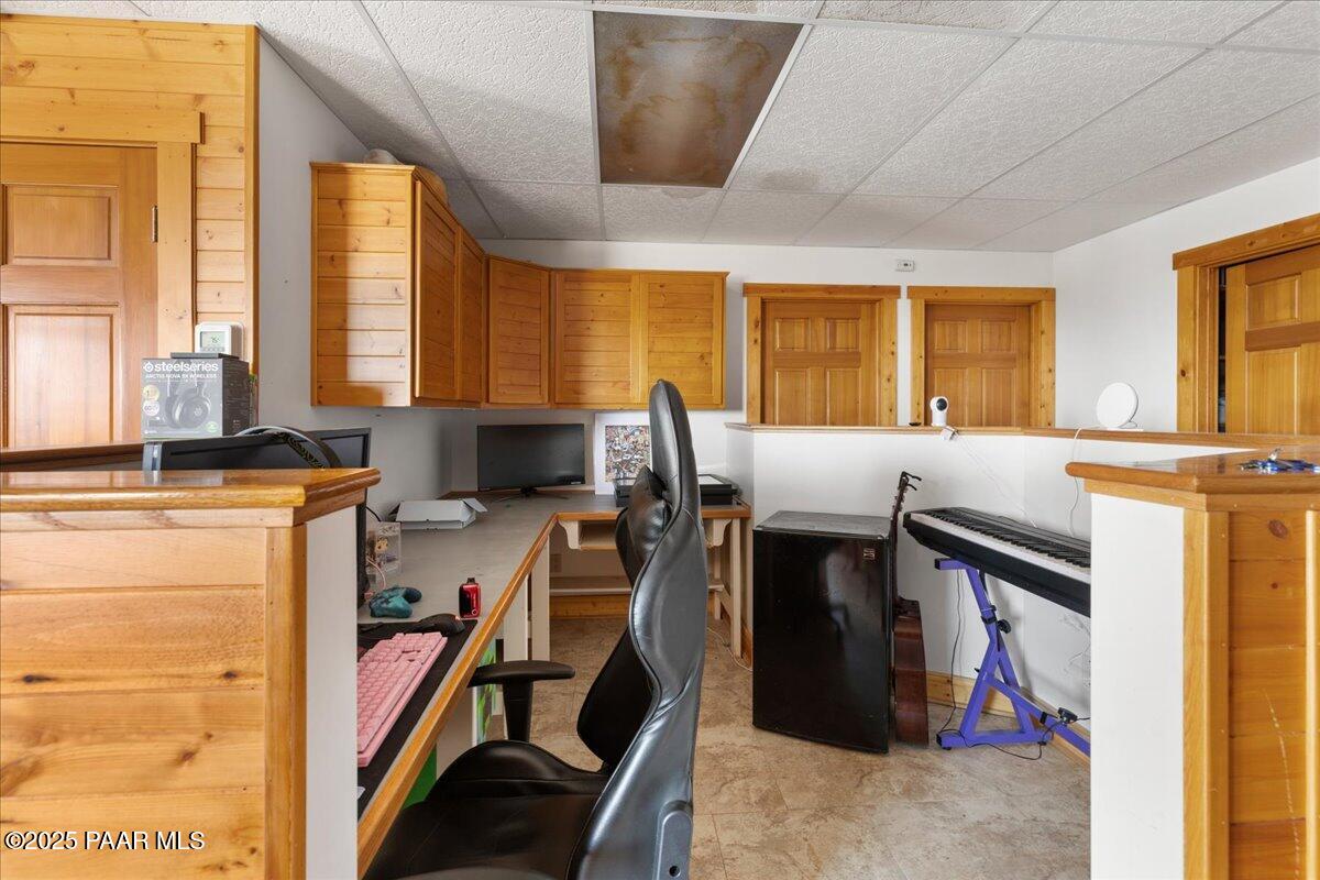 14195 Tapper Trail Prescott, AZ 86305 - Photo 37 of 46 a bed room with a bed and a computer on a desk next to a window